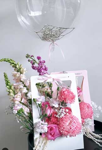 cute box of flowers with ballon